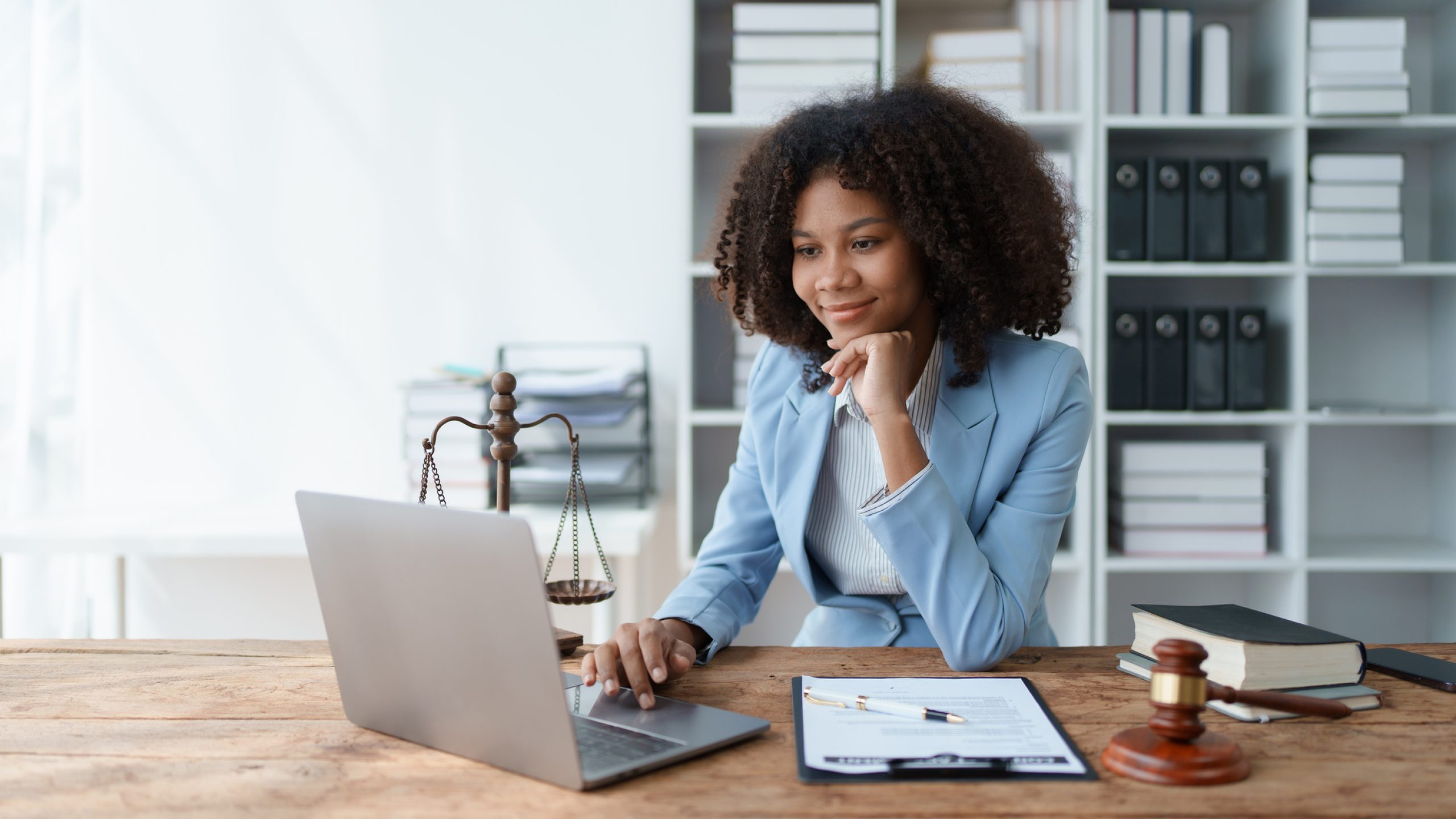 A young women African American lawyer lawsuit studying cases for clients in a law firm to fight against their parties in the courts. law and attorney concepts